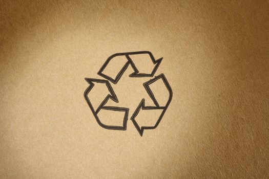 "Recyclable" universal symbol, printed on brown cardboard