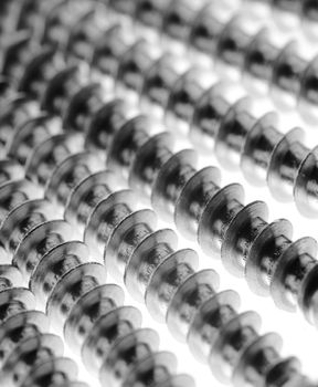 Closeup of stainles steel screws. Short depth of field