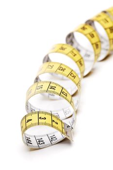 A yellow and white tape measure, metric system