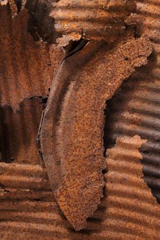 Rusty remains of a metallic oil barrel