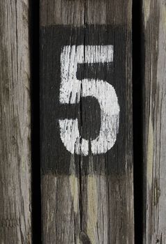 Number five painted on wood
