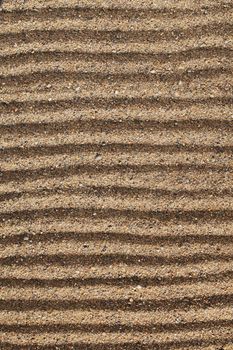 Horizontal lines drawn into coarse sea sand.