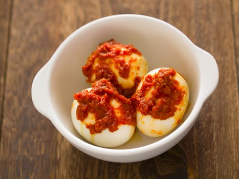 close up of a bowl of sambal chili eggs