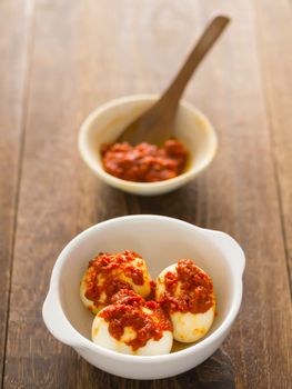 close up of a bowl of sambal chili eggs