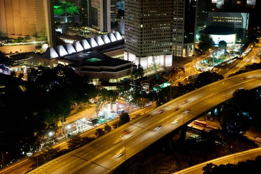 photo of singapore roads and buildings at night
