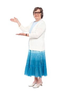 Beautiful aged female showing copy space isolated on white background