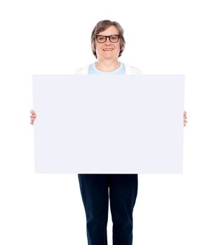 Aged woman displaying blank poster against white background