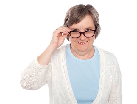 Attractive female holding her eyeglasses. Looking at you