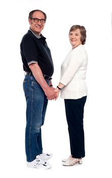 Love couple holding hands. Full length shot isolated over white