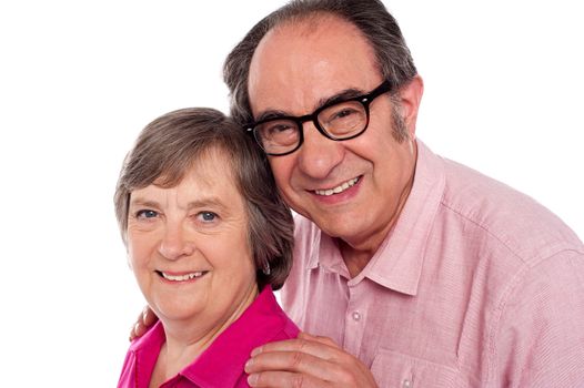 Closeup portrait of smiling aged couple looking at camera