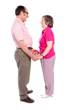 Man and woman holding each others hand. An aged couple