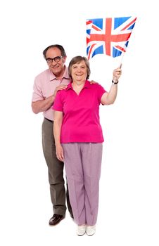 Old couple waving UK flag. Supporting nation and cheering