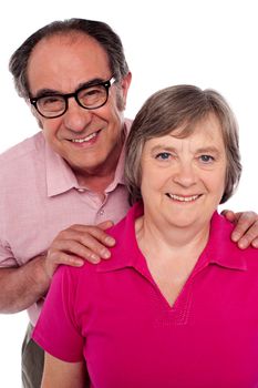 Closeup portrait of smiling matured couple. Man with hands on his wife's shoulder