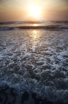 Seascape vertical photo of the ocean during twilight and sunset. Dark colors for the dramatic effect