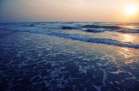 Horizontal photo of the sea during sunset. Natural darkness and colors