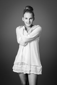 Smiling female model in front of a grey background