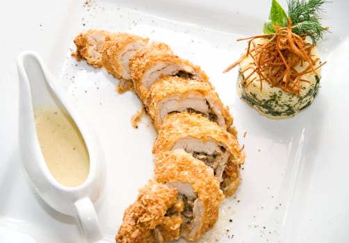 Close-up of Baked Chicken meat with sauceboat
