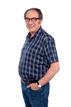 Man standing with hands in jeans pocket. Side view portrait
