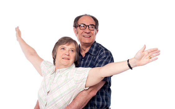 Senior love couple looking away. Woman posing with open arms