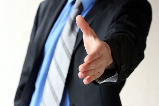 Young business man giving hand for handshake