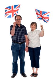 Senior citizens supporting their nation by holding flags