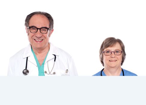 Closeup photo of smiling senior specialists with blank banner ad isolated on white background