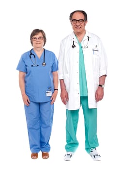 Two senior male and female physicians standing in front of camera