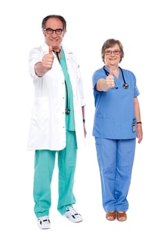 Senior medical representatives  gesturing thumbs up. Full length view