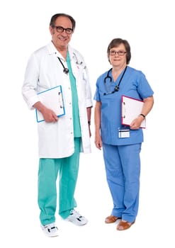 Senior male doctor posing with female nurse. Full length shot