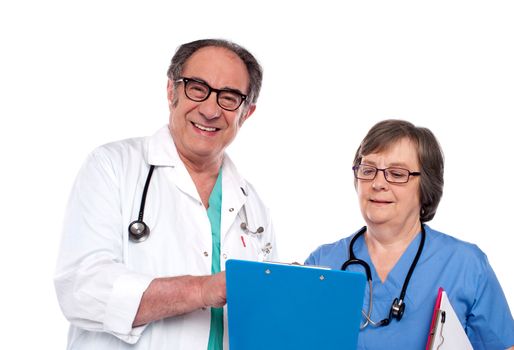 Senior doctors reading medical report isolated against white background