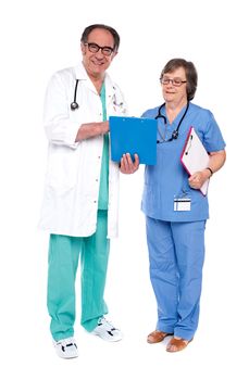 Doctor and nurse analyzing report together against white background