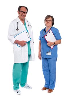 Two medical professionals standing together. Holding reports