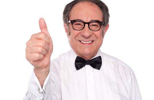 Closeup of senior male showing thumbs up to camera