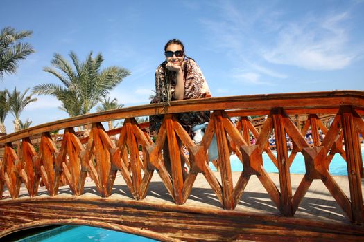woman posing on a bridge in the holiday