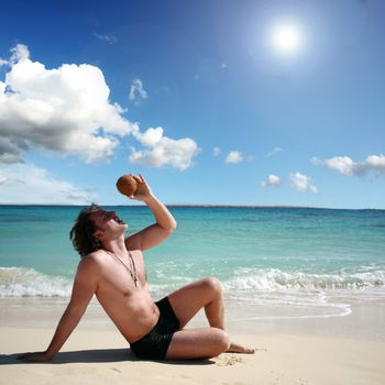 on vacation at the beach posing with coconut