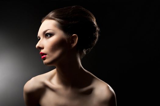 Portrait of a beautiful woman on a black background.