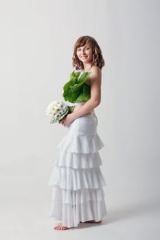 Happy woman with a wedding bouquet on white background.