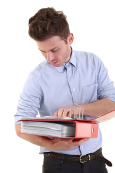 Young man checking documents in folders