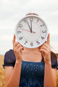 Female holds watches staying ourdoors