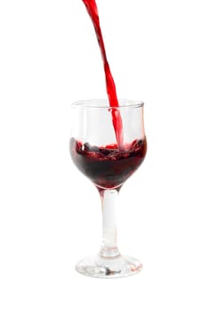 Red wine being poured into a wine glass isolated on white