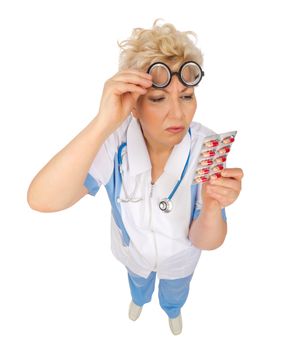 Funny mature doctor with pills isolated