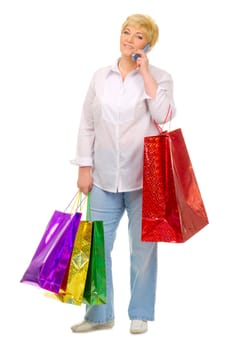 Senior woman with bags and mobile phone isolated