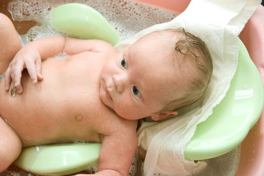 Swimming baby boy at the bath