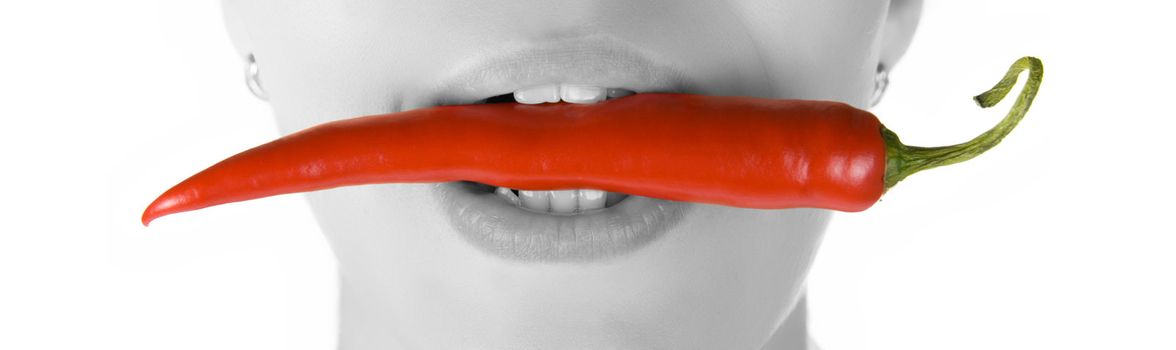 girl close up with chili pepper at her lips isolated on white