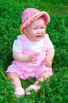 Small baby on green grass