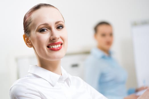 portrait of a business woman in office, smiling and looking into the camera, office work