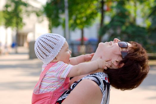 Woman playing with small baby