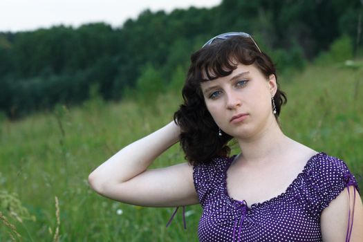 The girl a brunette with long hair in a wood