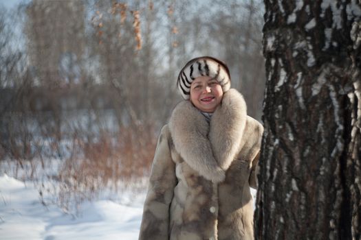 The woman of average years in a winter fur coat