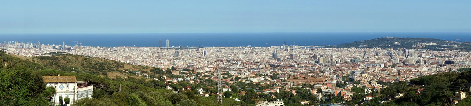 Wide panorama of Barcelona city at the Mediterranean Sea.               